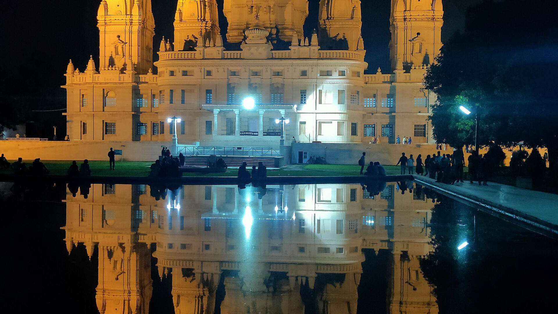 The J.K. Temple in Kanpur, lit at night and reflected in its water tank